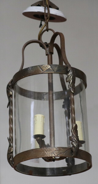 A circular wrought iron and glass hall lantern 41cm h x 21cm diam.  