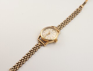 A lady's 14ct yellow gold Huguenin automatic wristwatch on a 9ct gold bracelet, gross weight 19.7 grams 