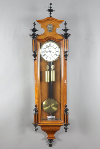 A Vienna style striking regulator, the 16cm dial with subsidiary second hand and Roman numerals, contained in a walnut and ebonised case 130cm h x 32cm w x 15cm d, complete with pendulum key and weights, the clock is currently running 