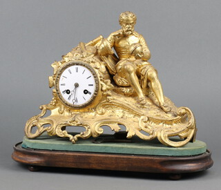 A 19th Century French mantel clock with enamelled dial, Roman numerals, contained in a gilt painted spelter case decorated a navigator contemplating a globe supported by instruments 26cm h x 35cm w x 10cm, complete with pendulum and key 