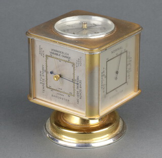 An Angelus Meteo desk top weather station alarm clock, the top inset a compass, the sides with barometer, thermometer, hygrometer and 8 day alarm clock, contained in a square revolving gilt metal case on a spreading foot, the base marked 883 Swiss, 10cm h x 7cm w x 7cm d 