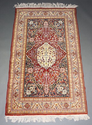 A  brown, blue and green ground Persian rug with central medallion within a multi row border 213cm x 123cm 