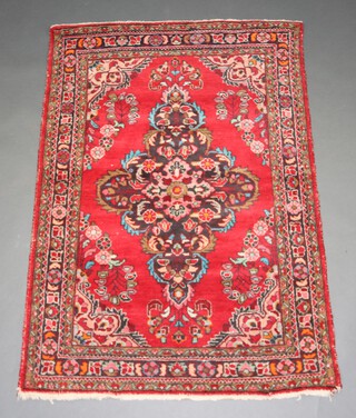 A red and blue ground Persian rug with central medallion 162cm x 114cm 