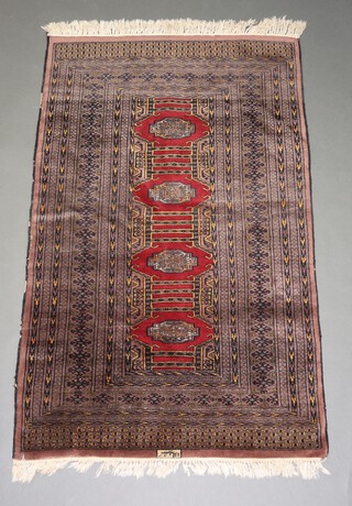 A brown, black and tan ground Bokhara  rug with 4 stylised octagons to the centre within a multi row border and signed 158cm x 96cm 