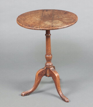 An 18th Century circular oak wine table raised on a turned column and tried base 68cm h x 51cm diam. 