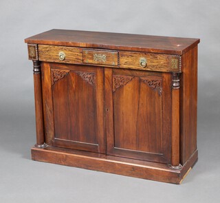 A William IV rosewood chiffonier fitted a drawer above cupboard enclosed by a panelled door with blind fretwork decoration flanked by columns to the sides 76cm h x 104cm w x 36cm d 