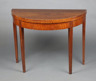 A Georgian style mahogany demi-lune card table raised on square tapered supports 74cm h x 95cm w x 48cm d 