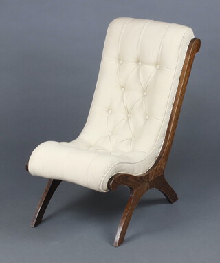 A Victorian beech framed slipper shaped nursing chair upholstered in white buttoned material 65cm h 