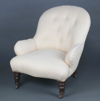 A Victorian metal framed armchair upholstered in white buttoned material raised on turned supports, 79cm h x 66cm w x 62cm d (seat 33cm x 39cm) 