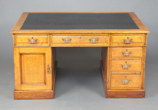 A Victorian light oak kneehole partners desk with inset writing surface above 1 long and 8 short drawers, the pedestal fitted cupboards with brass drop handles 72cm h x 137cm w x 90cm d 
