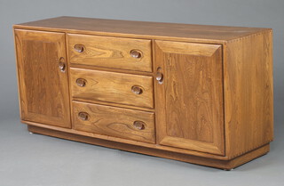 Ercol, a dark elm Windsor sideboard fitted 3 drawers flanked by cupboards 68cm h x 155cm w x  43cm d 