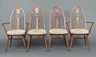 Ercol, a set of 4 hoop back dining chairs with pierced carved slats decorated swans, raised on turned supports 100cm h x 44cm w x 43cm d comprising 2 carvers, 2 standard 