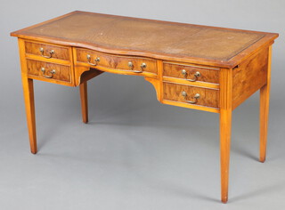 A Georgian style yew writing table with brown inset writing surface, the base with 2 brushing slides above 1 long and 4 short drawers, raised on square tapered supports 76cm h x 136cm w x 65cm d (contact marks in places) 