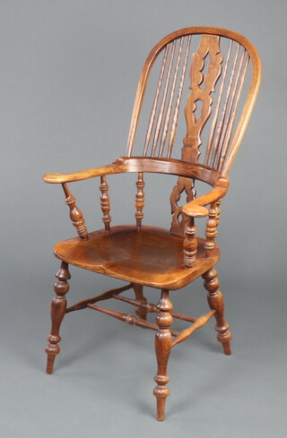 An 18th Century style elm slat back Windsor carver chair with solid seat, raised on turned supports and double H framed stretcher 118cm h x 68cm w x 45cm d (light scratch to seat)