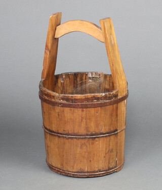 An Eastern style hardwood well bucket 53cm h x 30cm diam. 