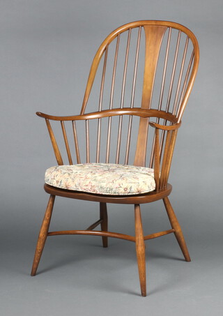 Ercol, an elm and beech Chairmaker carver chair with solid seat and crinoline stretcher, raised on turned supports 109cm high x 61cm w x 47cm d 