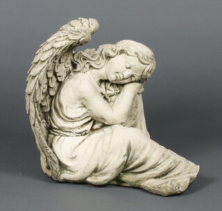 A concrete garden figure of a seated angel 36cm h x 37cm w x 30cm d 