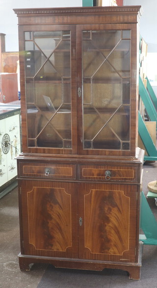 A Georgian style mahogany bookcase on cabinet with moulded cornice, fitted shelves, enclosed by astragal glazed panelled doors, base fitted  a drawer above double cupboard on bracket feet 190cm h x 91cm w x 39cm d 