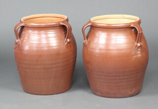 A near pair of terracotta 3 handled plant pots 48cm h x 34cm diam.  