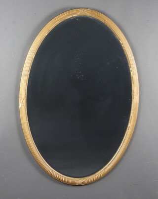 A 19th Century oval bevelled plate wall mirror contained a ribbon and reeded ball studded gilt frame 94cm x 64cm 
