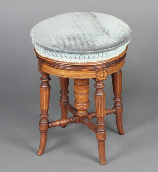 An Edwardian circular inlaid mahogany revolving piano stool on turned supports with X framed stretcher 46cm h x 37cm w 