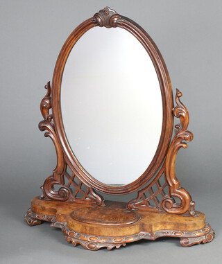 A Victorian oval plate dressing table mirror contained in a carved and pierced stand, the shaped base fitted a trinket box with hinged lid 87cm h x 77cm w x 31cm d 