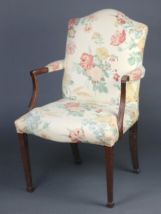 A 19th Century  mahogany open arm library chair, the seat and back upholstered in floral material raised on square tapered supports, spade feet 100cm h x 63cm w x 51cm d 