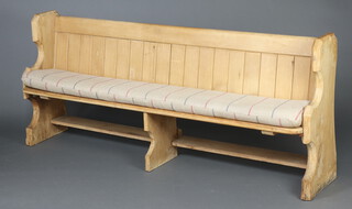 A Victorian pitch pine pew with raised back 86cm h x 198cm w x 36cm d (seat 189cm x 28cm) complete with a cushion 