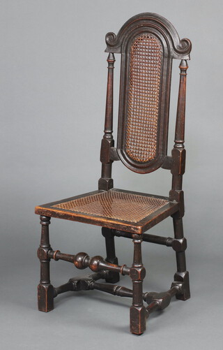 A 17th/18th Century carved oak high back chair with woven cane back and seat with columns to the sides, raised on turned and block supports, 105cm h x 45cm w x 38cm d (seat 23cm x 26cm) 