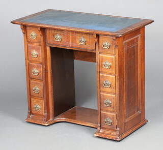 A Victorian mahogany desk with blue leather writing surface, fitted 1 long drawer flanked by 5 drawers and cupboard in the form of 5 drawers, formerly a sewing machine cabinet 74cm h x 87cm w x 44cm d 