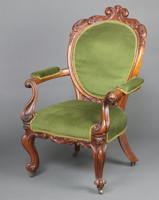 A Victorian carved mahogany show frame open armchair the seat and back upholstered in green material on cabriole supports 99cm h x 61cm w x 48cm d (seat 29cm x 33cm) 