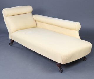 An Edwardian mahogany chaise longue upholstered in pale yellow material raised on turned supports with casters 70cm h x 176cm w x 62cm d (seat 112cm x 48cm) 