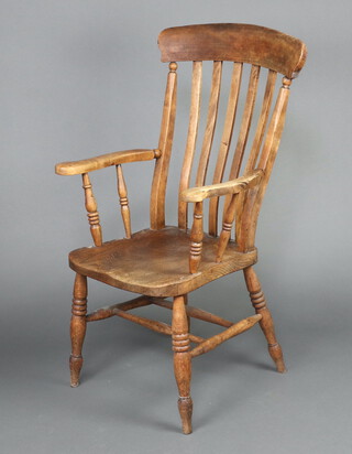 A 19th Century elm and beech comb back carver chair with solid seat 112cm h x 60cm w x 44cm d (seat 29cm x 30cm) 