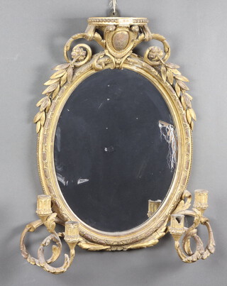 A 19th Century  oval plate wall mirror contained in a gilt plaster frame with 4 candle sconces 60cm x 40cm 