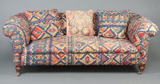 A Victorian Chesterfield upholstered in Kilim style material, raised on turned supports 70cm h x 195cm w x 83cm d