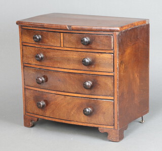 A 19th Century  mahogany bow front apprentice chest fitted 4 long drawers on bracket feet with tore handles 30cm x 32cm x 21cm 