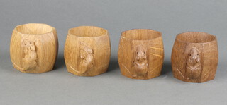 Robert "Mouseman" Thompson of Kilburn, a set of 4 octagonal carved oak napkin rings, each with a carved mouse, 5cm x 5cm 