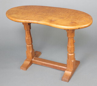 Robert "Mouseman" Thompson of Kilburn, a figured elm and oak kidney shaped table, raised on octagonal baluster turned columns with H framed stretcher, the leg carved a mouse  74cm h x 107cm w x 49cm d 