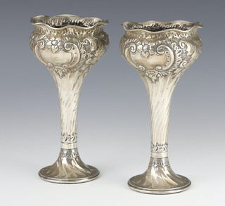 A pair of Edwardian repousse silver tapered spill vases decorated with flowers Birmingham 1902, 18cm 