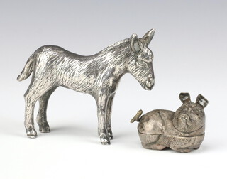 A Continental white metal box in the form of a reclining pig 5cm and a silver plated model of a donkey 
