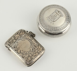 An Edwardian engraved silver vesta Birmingham 1907 and a Continental silver pill box Ypres 44 grams 