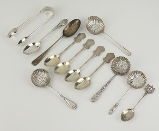 A pair of silver sugar nips London 1936, 11 silver spoons 194 grams 