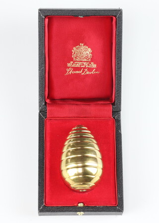 A Stuart Devlin silver gilt ribbed egg containing enamelled flowers, bees and cultured pearls numbered 74 of London 1986, 6cm, 74.3 grams 