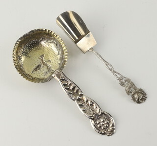 A repousse silver gilt strainer spoon, together with a ditto sugar shovel, 37 grams 