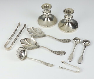 A pair of dwarf silver candlesticks Birmingham 1966 8cm, 2 pairs of sugar nips and 5  spoons 