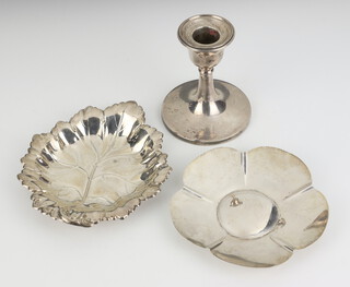 A silver leaf shaped dish Birmingham 1972, a silver flower head dish and a dwarf candlestick