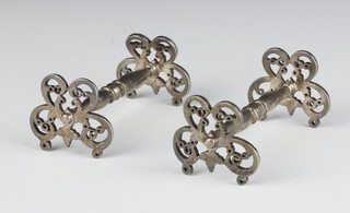 A pair of George IV silver knife rests with pierced decoration London 1828 with engraved crest, 99 grams