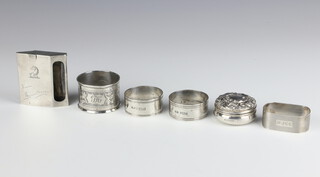 A sterling silver matchbook holder engraved a monogram, 4 napkin rings and a pill box 131 grams 