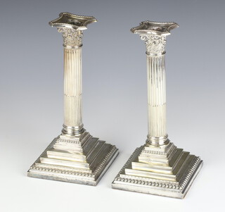 A pair of silver plated Corinthian column candlesticks 26cm 