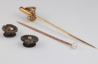 A yellow metal tie pin in the form of a sword, a pearl mounted ditto and 2 studs 